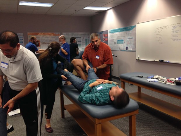 Attendees practice treatment techniques on one another